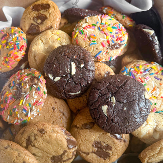Assorted box of mini cookies including chocolate chip, double chocolate, marble and sprinkled confetti.