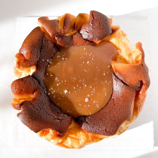 Burnt basque cheesecake topped with a pool of caramel and sprinkled with flakey sea salt.