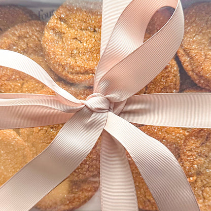 Box with chewy gingerbread cookies, wrapped with pink bow ribbon.