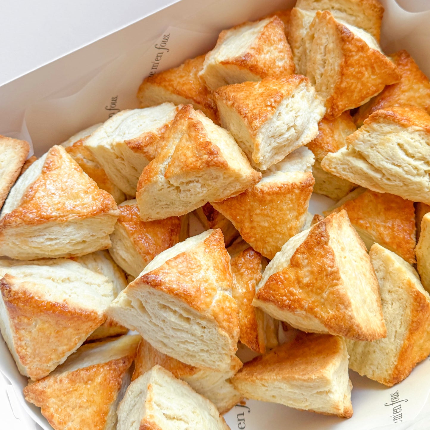 White box filled with triangle shaped scones.