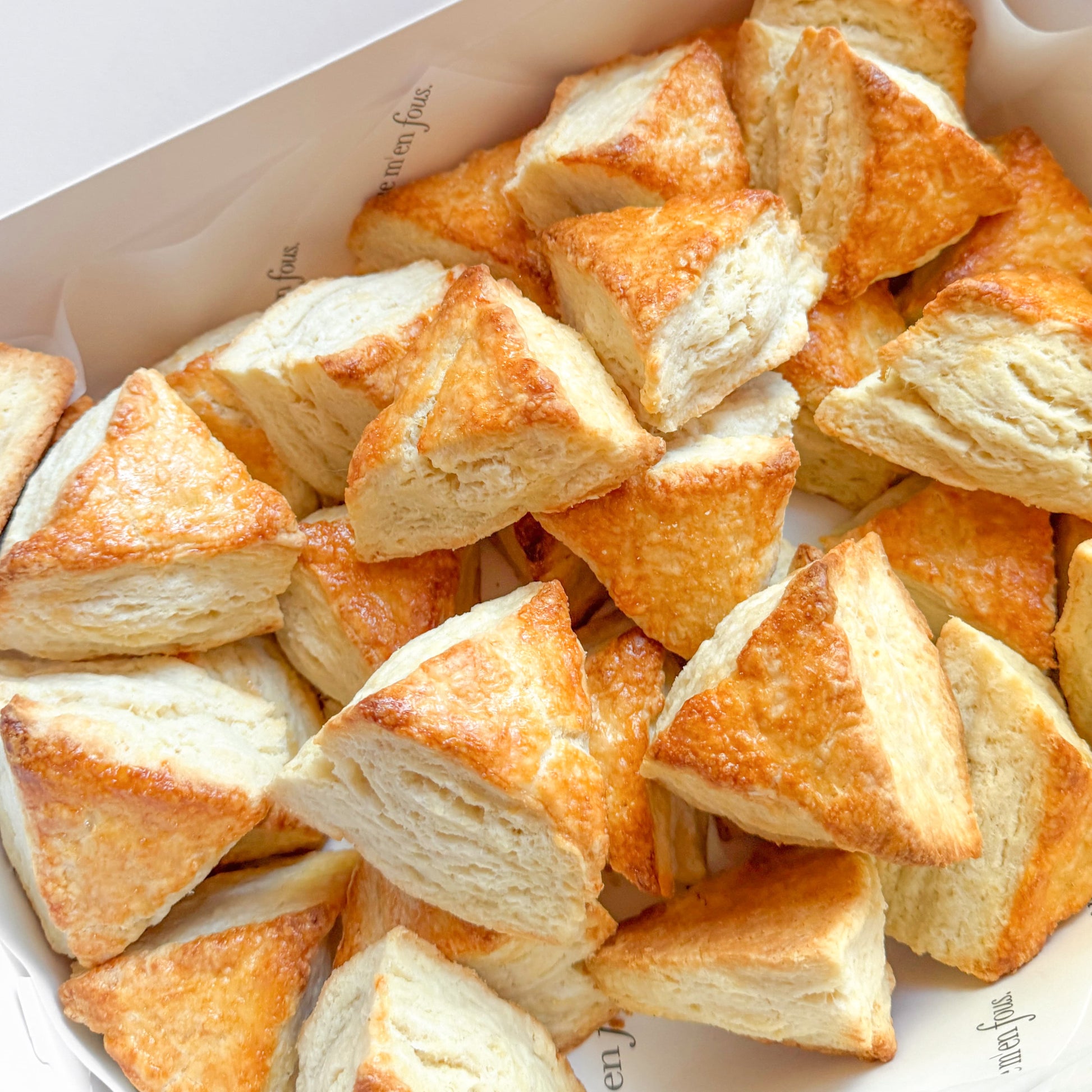 White box filled with triangle shaped scones.