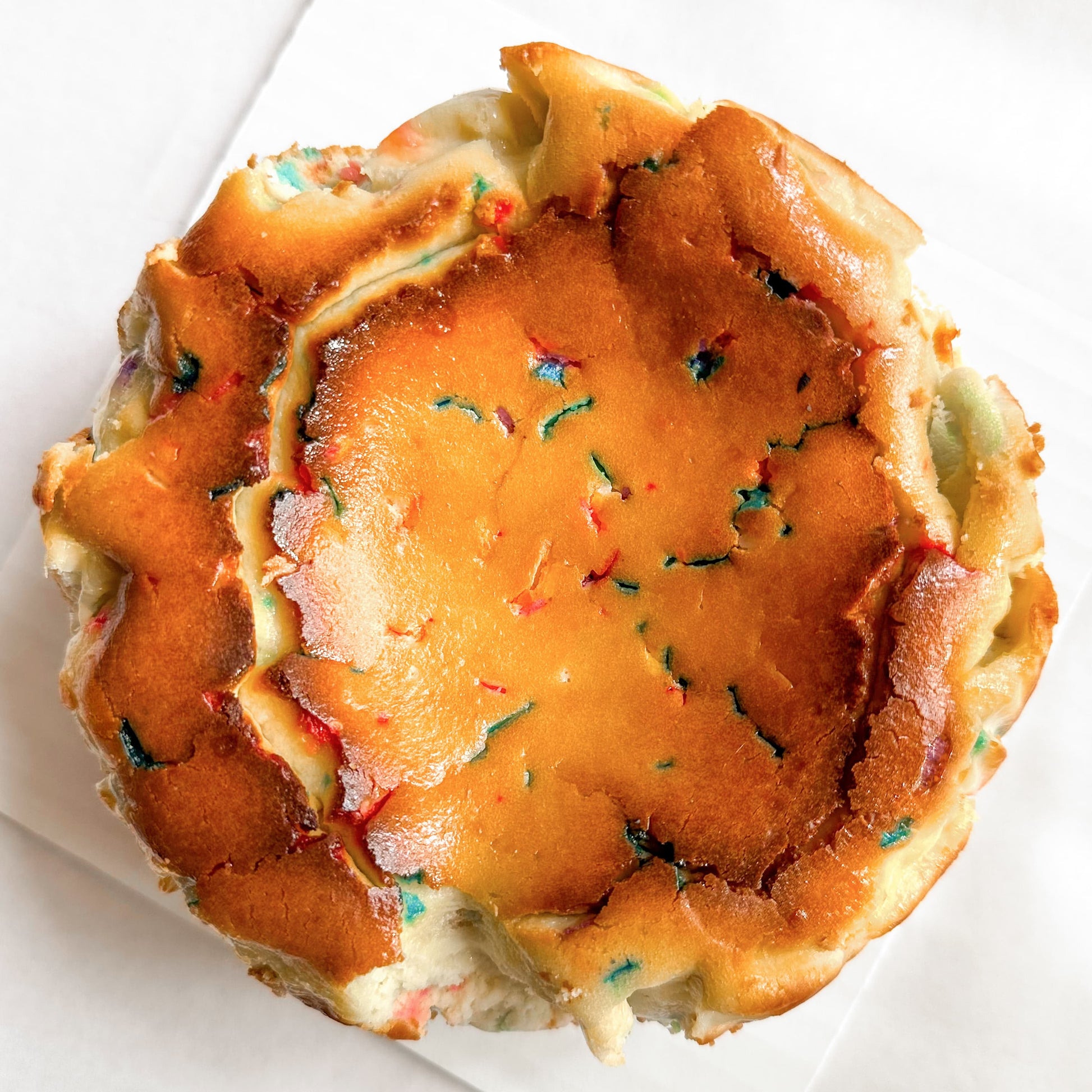 Birthday burnt basque cheesecake with rainbow sprinkles.